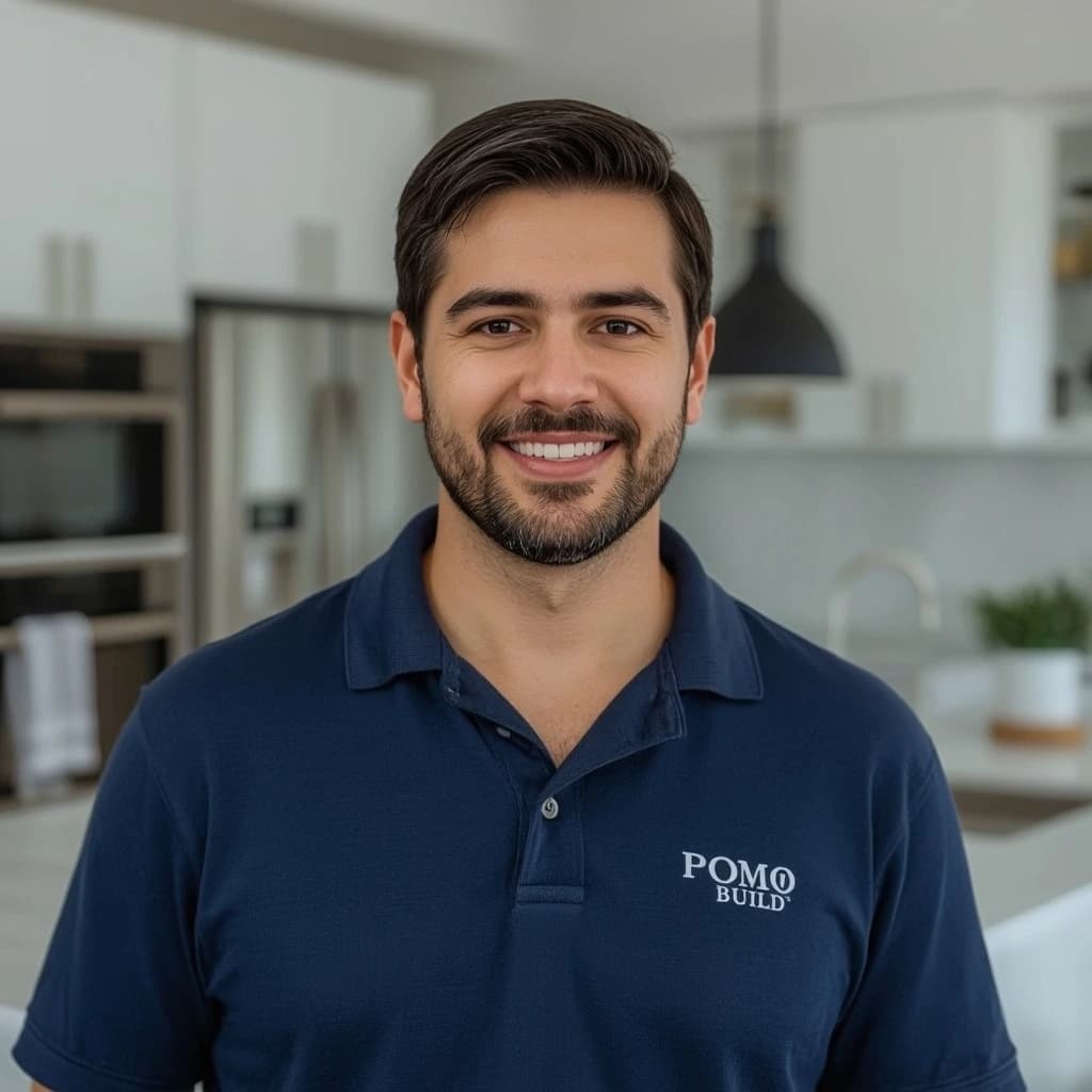 Saman Zen, owner of Pomo Build, smiling in a recently renovated kitchen.