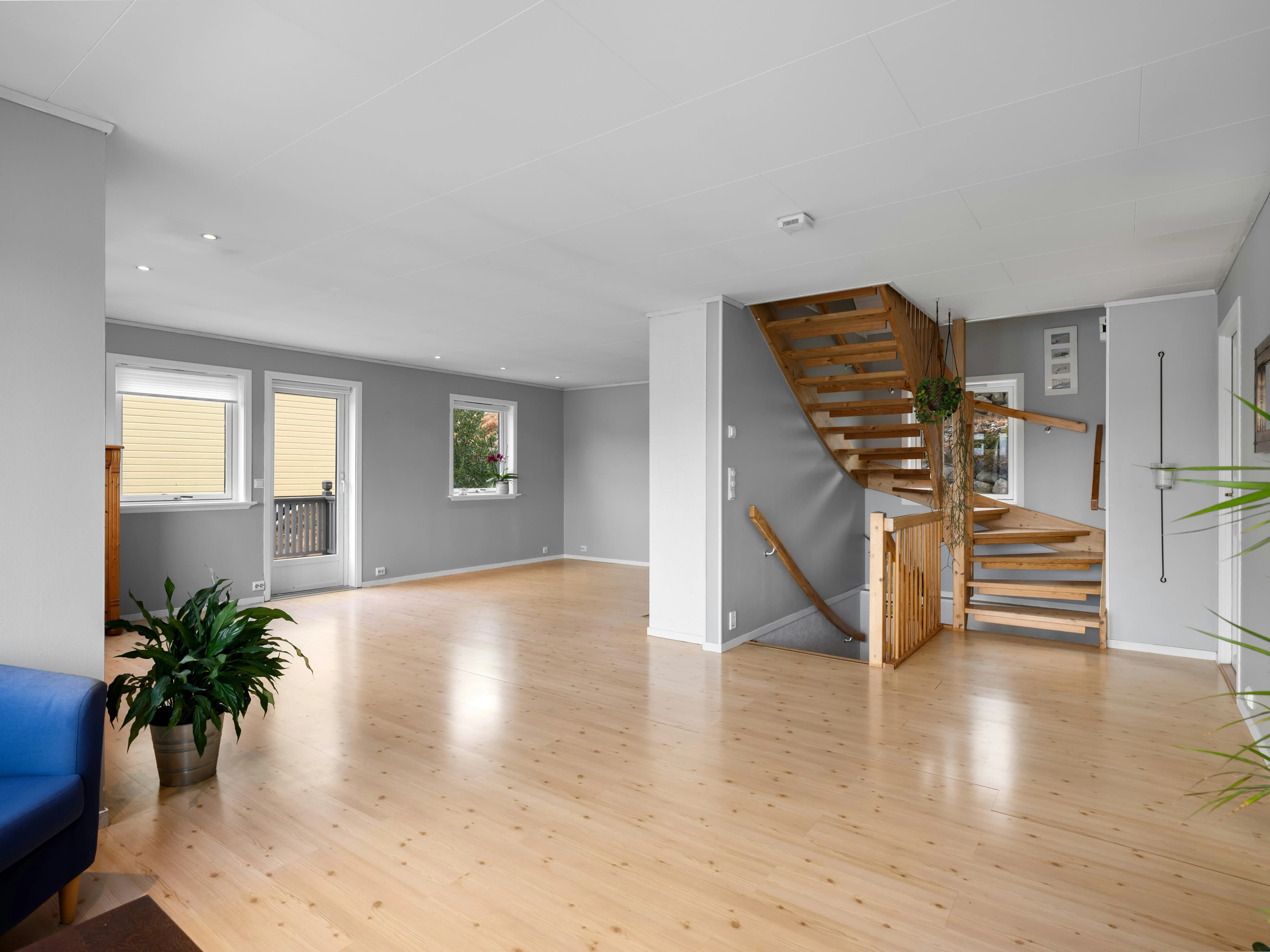 A stylish and comfortable finished basement living area by Pomo Build.