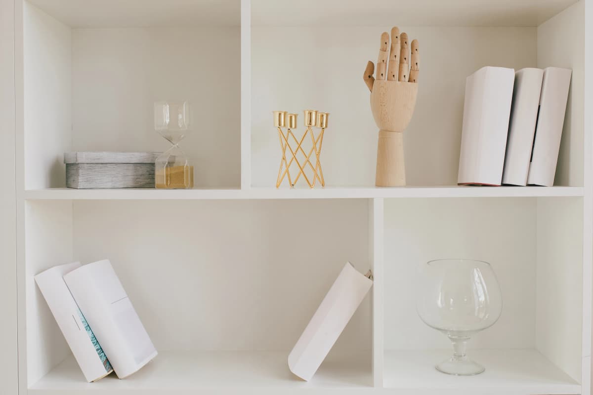 A newly assembled white bookshelf standing perfectly in a living room.