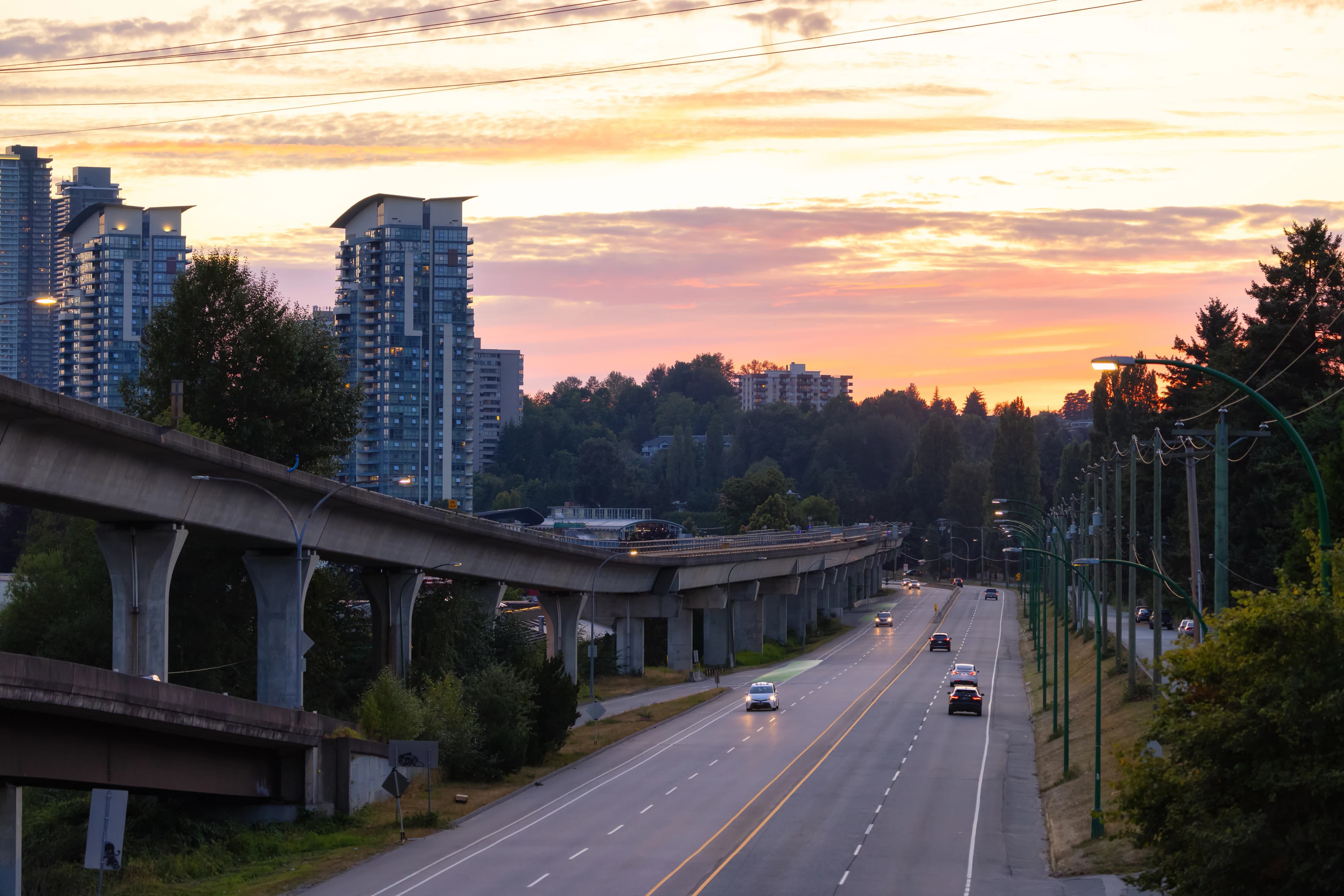 A residential street in Burnaby with the Metrotown skyline in the distance.